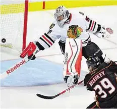  ?? AP ?? Winning shot Anaheim Ducks left wing Matt Beleskey (right) scores the game-winning goal past Chicago Blackhawks goalie Corey Crawford during overtime on Monday.