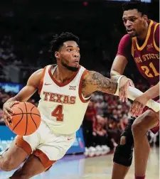  ?? Eric Gay/Associated Press ?? Texas guard Tyrese Hunter, who had 15 points against his former team, makes a move on Iowa State’s Osun Osunniyi.