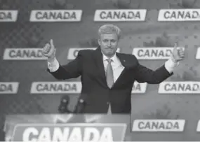  ?? TODD KOROL PHOTOS/TORONTO STAR ?? The defeated prime minister puts on a brave face as he exits the stage Monday.