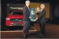  ??  ?? Bermaz Auto executive director Datuk Francis Lee (left) and Sakatani holding the mock key of the new Mazda CX-5 at its roll-out ceremony at the Kulim Plant yesterday.