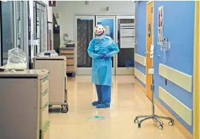  ?? [JAE C. HONG/ THE ASSOCIATED PRESS] ?? A nurse puts on protective gear Thursday in a COVID-19 unit in California.