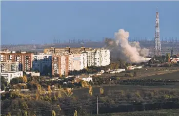  ?? LIBKOS AP ?? A plume of smoke rises after Russian shelling in Bakhmut, Ukraine, Saturday as fighting rages.