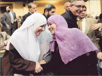  ?? Mohammed Asad Associated Press ?? EGYPTIAN LAWMAKERS greet one another at a brief session of the parliament, which reconvened at President Mohamed Morsi’s request despite a recent court ruling disbanding the legislativ­e body.