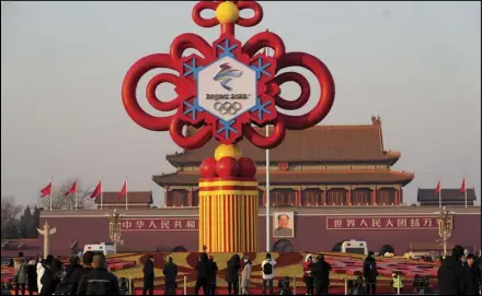  ?? ASSOCIATED PRESS ?? Residents look at a Beijing Winter Olympics decoration on Tiananmen Square in Beijing, China, Tuesday.