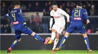  ?? — AFP photo ?? Juventus’ forward Cristiano Ronaldo (left) fights for the ball with Verona’s defender Koray Gunter (left) and Verona’s midfielder Miguel Veloso during the Italian Serie A match at the Marcantoni­o Bentegodi stadium in Verona in this Feb 8 file photo.