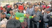 ?? PHOTOGRAPH: EUGENE COETZEE ?? NOWHERE TO GO: Former ANC councillor Thembinkos­i Mafana (navy jacket) listens to Wells Estate residents’ complaints yesterday