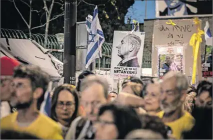  ?? ?? Weakened: Protestors (above) demonstrat­e outside Prime Minister Benjamin Netanyahu’s home calling for early elections and his ouster. Airstrikes hit three of World Central Kitchen’s vehicles (left), killing seven aid workers.