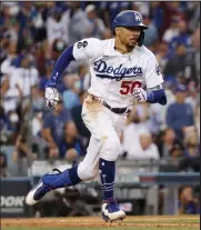  ?? Harry How / Getty Images ?? The Dodgers’ Mookie Betts gets base hit against the Cardinals during the NL Wild Card game on Wednesday at Dodger Stadium in Los Angeles.