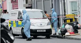  ??  ?? Officers look for forensic clues yesterday as the area is cordoned off