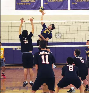  ?? Photos by Ernest A. Brown ?? Lincoln’s Daniel Hasegawa (8, left) has his attack blocked by St. Raphael’s Xavian Johnson, while SRA’s Patrick Bullen (5, right) takes a swing during his team’s three-set Injury Fund victory.