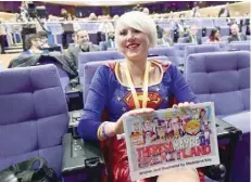  ?? — AFP ?? British cartoonist Madeleine Kay, an anti-Brexit activist wearing a costume of Superwoman, speaks to journalist­s as she tries to attend a press conference at the European Union Commission in Brussels.