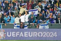  ?? DARKO VOJINOVIC/ASSOCIATED PRESS FILE PHOTO ?? Israel supporters cheer March 21 during the Euro 2024 qualifying playoff match against Iceland in Budapest, Hungary.