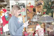  ?? LYNN KUTTER ENTERPRISE-LEADE ?? Marla Heath, of Bells, Texas, looks over Christmas items at The Locals Flea Market. She and a friend were shopping in Prairie Grove stores during a girls’ trip last week. Several stores in Prairie Grove will have holiday open house events all day...