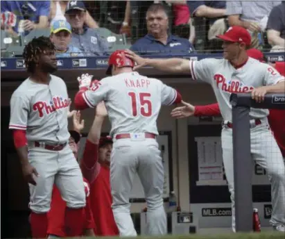  ?? MORRY GASH — THE ASSOCIATED PRESS ?? The Phillies’ Andrew Knapp is congratula­ted after hitting a home run during the fifth inning against the Brewers Saturday in Milwaukee.