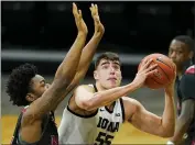  ?? CHARLIE NEIBERGALL — THE ASSOCIATED PRESS ?? Iowa center Luka Garza drives to the basket ahead of Northern Illinois forward Chinedu Okanu, left, during the first half of Sunday’s game in Iowa City, Iowa.