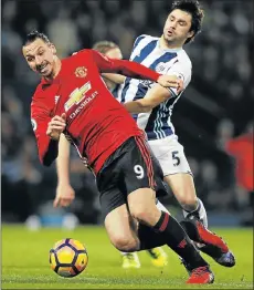  ?? Picture: REUTERS ?? TWO-GOAL HERO: West Bromwich Albion’s Claudio Yacob, back, attempts to challenge Manchester United striker Zlatan Ibrahimovi­c during their Premier League match at The Hawthorns