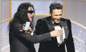  ?? PAUL DRINKWATER/NBC VIA THE ASSOCIATED PRESS ?? James Franco, right, accepts his Golden Globe Award for best actor in a motion picture comedy or musical for “The Disaster Artist” as director Tommy Wiseau looks on.