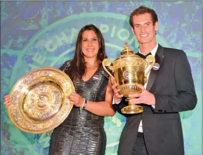  ??  ?? HOME RULE: Men’s singles champion Andy Murray and women’s singles champion Marion Bartoli pose with their trophies during the Wimbledon Champions Ball Sunday in London. Murray became the first Brit since Fred Perry 77 years ago to win Wimbledon,...