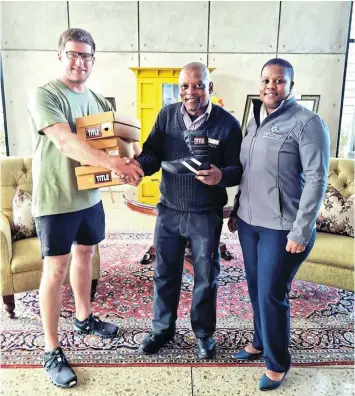  ?? Picture: SUPPLIED ?? HEAVYWEIGH­T DONATION: Royal St Andrews Hotel owner Justin Bekker hands over boxing boots to Nemato’s Masambisan­e Boxing Academy founder Monwabisi Hans. On the right is banqueting manager Phumlani Mazana.