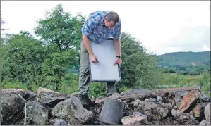  ?? 06_a32Auchind­rain02 ?? Archaeolog­ist Johnnie Gallacher of GUARD Archaeolog­y records the site.