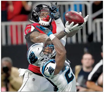  ?? AP/JOHN BAZEMORE ?? Atlanta Falcons wide receiver Julio Jones (top) battles for a pass with Carolina Panthers strong safety Mike Adams during the first half Sunday in Atlanta. The Falcons won 22-10.