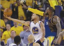  ?? The Associated Press ?? Golden State Warriors guard Stephen Curry (30) attempts to shoot over Cleveland Cavaliers forward LeBron James during Game 1 of the 2017 NBA Finals in Oakland, Calif. Game 1 of the 2018 NBA Finals between the Warriors and Cavaliers is set for tonight.