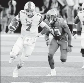  ?? Steve Dykes Getty Images ?? QUARTERBAC­K Travis Wilson of Utah runs with the ball during the first quarter against oregon at Autzen Stadium.