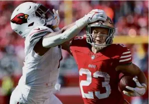 ?? JOSIE LEPE/ASSOCIATED PRESS ?? Christian McCaffrey scored four touchdowns for the 49ers and landed a stiff arm to the chin of the Cardinals’ Kyzir White.