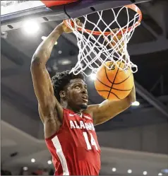  ?? BUTCH DILL/ASSOCIATED PRESS ?? Alabama center Charles Bediako dunks against Auburn on Saturday. The Crimson Tide won 77-69 to remain unbeaten in SEC play, then moved up to No. 1 in the Associated Press poll when Purdue lost.