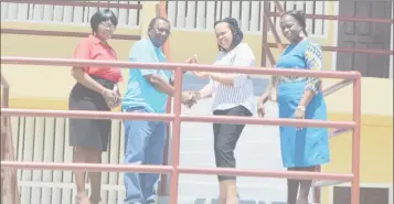  ??  ?? Managing Director of Ivor Allen Contractin­g Services, Ivor Allen, hands over the keys to the Golden Grove Secondary School to Region Four Regional Executive Officer Pauline Lucas. Flanking them are Regional Education Officer Tiffany Favourite-Harvey...