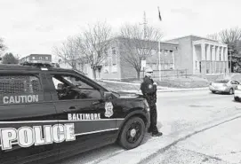  ?? AMY DAVIS/BALTIMORE SUN ?? Officer Ken Patzman stood outside the Southweste­rn District to assist citizens when the Font Hill Avenue station was closed after an officer tested positive for COVID-19.