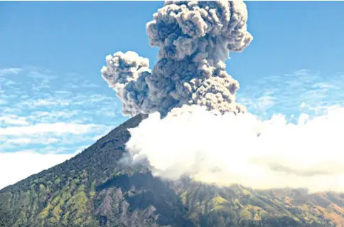  ??  ?? Mount Agung seen spewing ash early yesterday.