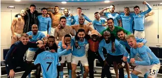  ??  ?? All together now: City celebrate another late win in their dressing room