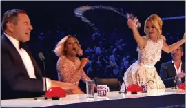  ??  ?? MAKING A SPLASH: Amanda Holden throws water over David Walliams