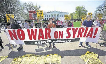  ?? AFP ?? Demonstrat­ors take part in a protest against the US bombing of Syria in front of the White House.