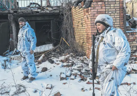  ?? ?? Ukrainian soldiers Anatoliy and Katya patrol the front line near the village of Pisky as Russia sends troops to neighbouri­ng Belarus. Picture: Getty