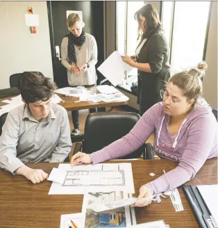  ?? PHOTOS: BRANDON HARDER ?? Hugh Douglas, left, and Mackenzie Kotylak work together on a floor plan for a tiny house during a workshop held at the Caledonian Curling Club in Regina.