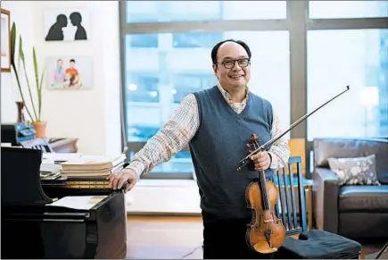  ?? E. JASON WAMBSGANS/CHICAGO TRIBUNE ?? Chicago Symphony Orchestra concertmas­ter Robert Chen, pictured in his home on Monday, was born and spent the first years of his life in Taipei.