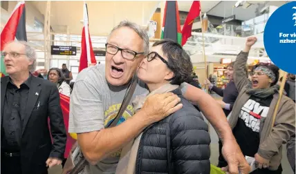  ?? Photo / Brett Phibbs ?? Mike Treen is welcomed by partner Heidi Jia and pro-Palestine campaigner­s at Auckland Airport.