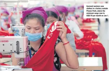  ??  ?? Garment workers sew clothes in a factory outside Phnom Penh, where the minimum wage rose to US$170 per month on Jan 1.