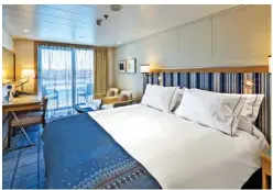  ??  ?? Scandinavi­an-style stateroom with balcony;