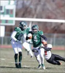  ?? JOHN BLAINE — FOR THE TRENTONIAN ?? Steinert’s Will Laster (4) tries to break a tackle attempt by Hamilton’s Bryon Hearst (7) during Thursday’s Thanksgivi­ng game.