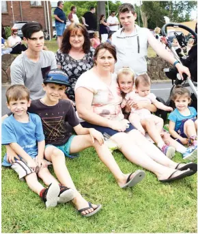  ??  ?? Top: Crowds gather for the annual Ficifolia Festival street parade in Drouin on Saturday. Inset: Among the crowd was the Phillips family including (back) Brendan, Colette Ballard, Caleb, (front) Lucas, Patrick, Rachel, Madeleine, Adele and Arwen. More...