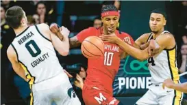  ?? JIM SLOSIAREK/AP ?? Maryland forward Julian Reese, center, is double-teamed by Hawkeyes forwards Filip Rebraca, left, and Kris Murray during the second half of Sunday’s game in Iowa City, Iowa.