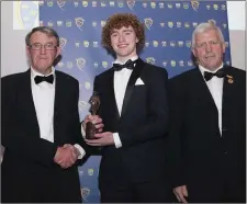  ??  ?? Paul Walsh accepting the Minor Footballer of the Year award from Munster GAA Vice-Chairman Liam Lenihan, left, and Munster GAA Chairman Jerry O’Sullivan at the 2018 Munster GAA Awards