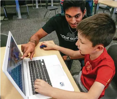  ?? Steve Gonzales / Houston Chronicle ?? Bharath Balabaskar of Code Ninjas teaches Jake Bellard, 9, the art of coding this week at the Pearland center.