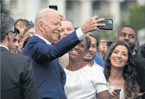  ?? AFP ?? President Joe Biden poses for a selfie with guests after delivering a speech during Independen­ce Day celebratio­ns at the White House in Washington, DC, on Sunday.