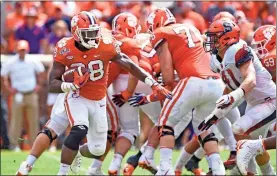  ?? / AP-Richard Shiro ?? Clemson’s Tavien Feaster breaks out of the backfield for a first down during the second half of Saturday’s game against Syracuse in Clemson, S.C. Clemson won 27-23.