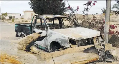  ?? AP PHOTO ?? A burned truck is seen outside Al-Rawda Mosque in Bir al-Abd northern Sinai, Egypt, a day after attackers killed hundreds of worshipper­s, on Saturday.