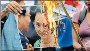  ?? AP ?? Activists burn a poster of Suu Kyi in Kolkata on Monday.